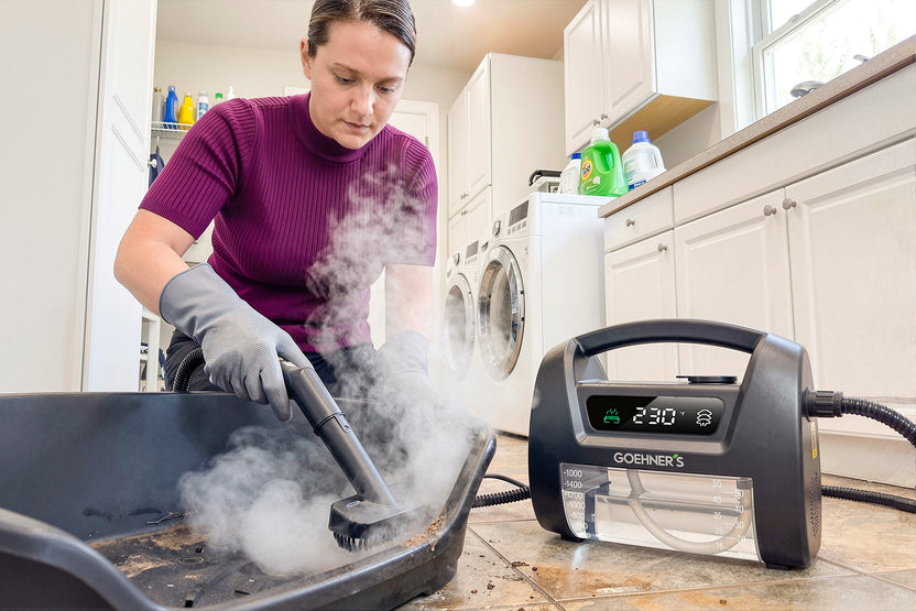 Steam-cleaning a pet litter tray with the chemical-free Goehner’s in the laundry room